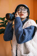 © Pansfun Images/Stocksy - Young Asian female photographer holding camera