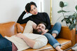 © Leah Flores/Stocksy - Affectionate Couple Reclined on Couch