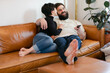 © Leah Flores/Stocksy - Happy Couple Watching TV