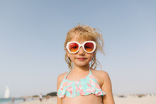 A Little Girl In Pink Sunglasses