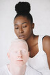 © Jovana Rikalo/Stocksy - Portrait of a young black woman and male albino