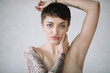 © Jovana Rikalo/Stocksy - Portrait of a young tattooed woman