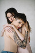 © Jovana Rikalo/Stocksy - Portrait of a young tattooed woman and woman with vitiligo