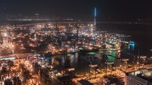 Commercial Port Of Lai King, Hong Kong Night Timelapse. Bird Eye Panoramic Aerial View Of Busiest Asian Cargo Port With Hundreds Of Ships Loading Export And Import Goods And Containers In Harbor.