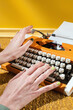 © Audrey Shtecinjo/Stocksy - Stylish Yellow hands typing on Typewriter