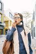 © Pansfun Images/Stocksy - Young Asian woman eating snacks