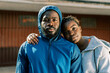 © Javier Díez/Stocksy - Sporty couple in warm activewear standing on street