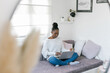 © Mihajlo Ckovric/Stocksy - Young black woman studying from home