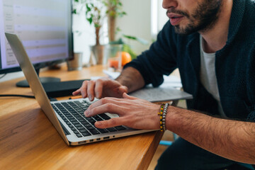 Hands typing on laptop computer