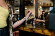 © Jimena Roquero/Stocksy - Detail shot of hand wearing a smart watch doing a wireless payment at a restaurant