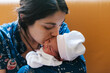 © Ezequiel Giménez/Stocksy - Loving mother kissing newborn baby