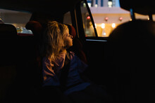 A girl in a car at night