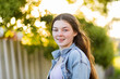 © Austockphoto - Portrait of happy 14 year old girl with bokeh background