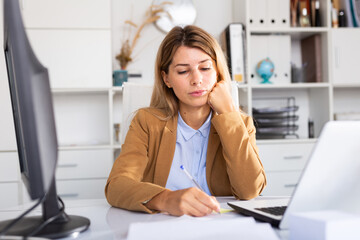 woman working on her laptop in white room