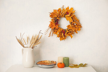 Table with autumn decor in interior of room