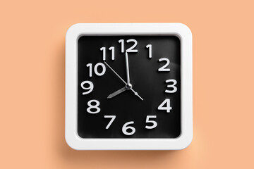 Stylish clock on color background