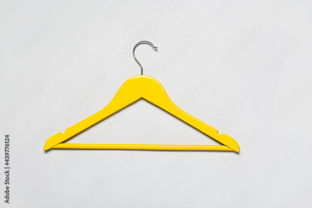 Stylish clothes hanger on light background