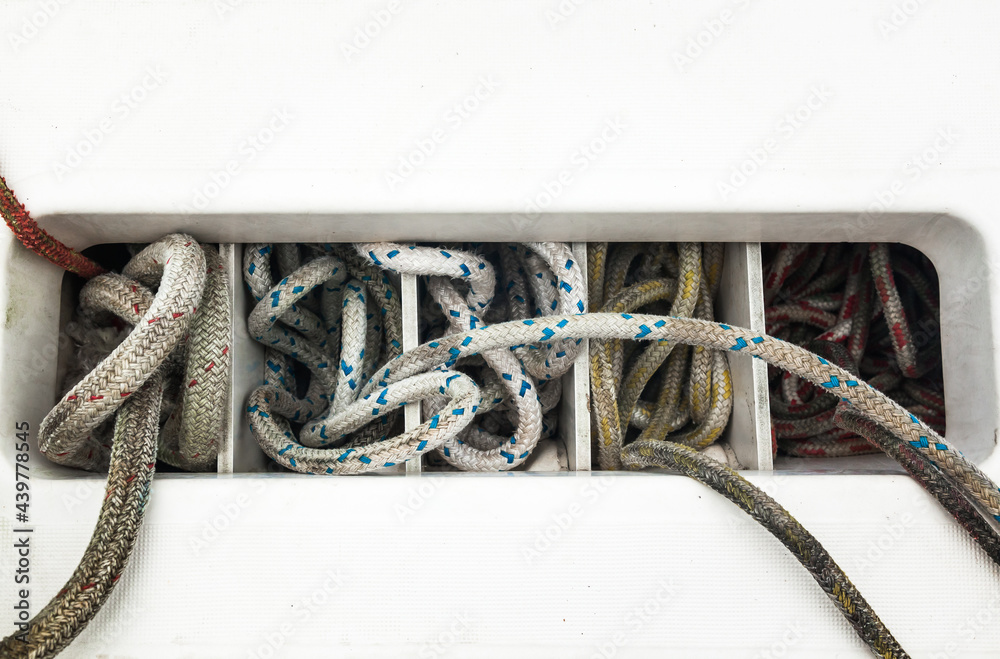 Yacht Rope Rack The ropes are stacked in cells on the hull of a sailing yacht, close-up ...