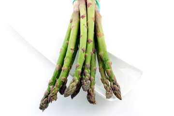 Wall Mural - Closeup shot of fresh asparagus isolated on a white background