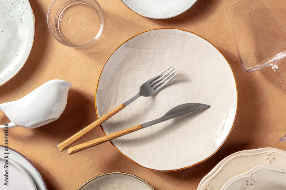 Modern tableware, overhead flat lay shot. Trendy plates, glasses, and cutlery, top view. Elegant dinnerware - obrazy, fototapety, plakaty 