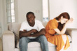 © SHOTPRIME STUDIO - young couple at home on the couch quarrel conflict