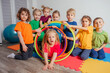 © oksix - Portrait of smiling children with hula hoops