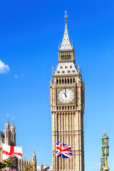 Fototapete - Big Ben with flag of England and United Kingdom in London against blue sky.