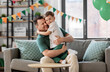 © Syda Productions - family, fatherhood and people concept - portrait of happy smiling father and little son hugging at home birthday party