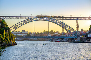 Wall Mural - Cityscape of Porto with Douro river and famous bridge by sunset, Portugal