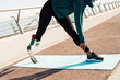 © Drobot Dean - Young sportswoman with prosthesis doing exercise while working out