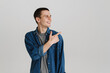 © Drobot Dean - Young brunette man smiling and pointing finger aside