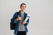 © Drobot Dean - Young student man gesturing thumb up while holding exercise books