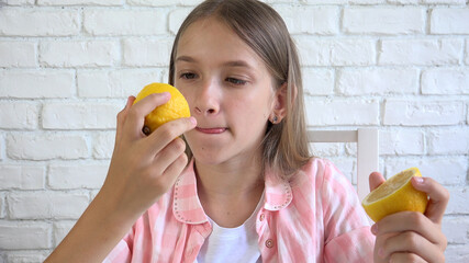 Kid Eating Lemon, Child Eats Fruits, Young Girl at Breakfast in Kitchen