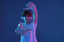 Caucasian Young Man Isolated On Blue Studio Background In Neon. Concept Of Human Emotions, Facial Expression.