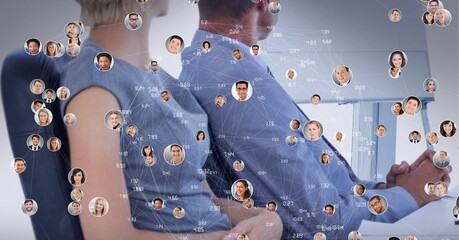 Poster - Network of profile icons against mid section of businessman and businesswoman at office