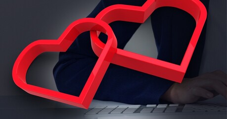 Poster - Two red hearts against against mid section of businessman using laptop