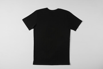 Wall Mural - Black T-shirt lying on a white background