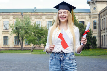 Wall Mural - Happy woman student graduate with Poland flag and diploma. Graduation day at the university. Extramural course graduate.  Distance education.