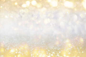 Wall Mural - Gold light Festive Christmas background. Abstract twinkled bright background with bokeh defocused golden lights