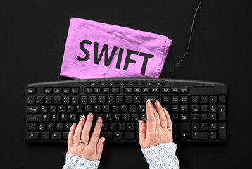 swift programming language. rag width word swift and hands on pc keyboard