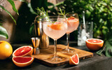 Fototapeta Lawenda - Pink grapefruit and rosemary gin cocktail is served in a prepared gin glasses