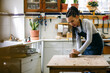 © Inuk Studio/Stocksy - Female carpenter working with plane in workshop