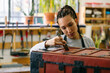 © Inuk Studio/Stocksy - Craftswoman varnishing wooden chest in workshop