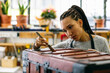 © Inuk Studio/Stocksy - Craftswoman varnishing wooden chest in workshop