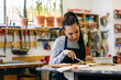 © Inuk Studio/Stocksy - Focused artisan woman working in restoration workshop