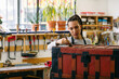 © Inuk Studio/Stocksy - Craftswoman varnishing wooden chest in workshop