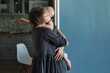 © Irina Polonina/Stocksy - Mother holds her little child in her cozy room.