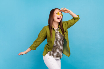 Wall Mural - Photo of happy young dreamy woman look empty space forward wear sunglass isolated on blue color background