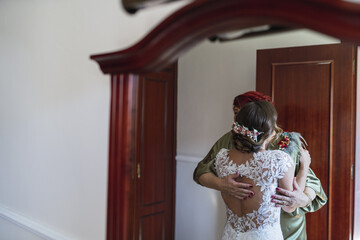 Wall Mural - Closeup shot of a beautiful bride hugging her mother before the wedding