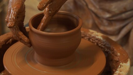 Wall Mural - Hands of a potter, creating an earthen jar on the circle. Woman makes hand made ceramics from clay